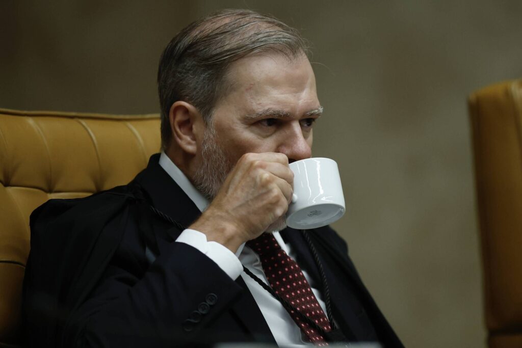 De acordo com a publicação da Folha de S.Paulo, no dia 2 de dezembro, o ministro José Antonio Dias Toffoli determinou o grau máximo de sigilo nas investigações relacionadas ao escândalo envolvendo o banco Master. A decisão gerou controvérsias e foi vista como uma ação que favoreceria interesses de figuras poderosas em Brasília. A publicação sugere que, em menos de um mês, o ministro Toffoli teria se tornado um aliado das tramas do banqueiro Daniel Vorcaro, que estaria no centro das investigações devido a uma rede de interesses financeiros. Ainda segundo a Folha, a imposição do sigilo máximo por Toffoli foi criticada e interpretada como uma tentativa de proteger os envolvidos no escândalo do banco Master. A publicação destaca que a medida foi recebida com desconfiança e que, em um curto período, o ministro foi afastado do caso, o que foi descrito como um "funeral de primeira" por seus pares. Essa expressão sugere que a retirada de Toffoli das investigações foi uma ação planejada e executada de forma a minimizar o impacto negativo de sua decisão inicial. A Folha de S.Paulo também menciona que a situação envolvendo o banco Master e o banqueiro Daniel Vorcaro continua a ser um tema de grande interesse público, especialmente devido às implicações políticas e financeiras que o caso representa. A publicação indica que a rede de interesses mencionada no escândalo pode ter ramificações significativas, afetando não apenas o setor bancário, mas também a esfera política em Brasília. O sigilo imposto por Toffoli, segundo a Folha, acabou por se tornar um "veneno", sugerindo que a tentativa de ocultar informações acabou por intensificar as suspeitas e a atenção sobre o caso.