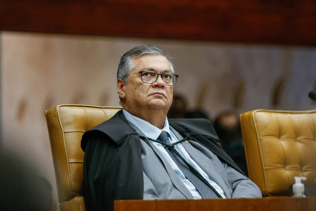 O **ministro Flávio Dino** tornou-se alvo de um pedido de **impeachment** devido à sua decisão de anular a quebra de sigilos do filho do ex-presidente Luiz Inácio Lula da Silva, conhecido como **Lulinha**, durante a Comissão Parlamentar Mista de Inquérito (CPMI) do INSS. A justificativa apresentada por Dino para essa anulação foi que a votação que determinou a quebra de sigilos ocorreu "no atacado", ou seja, de maneira abrangente e sem a devida individualização dos casos. Por que a anulação da quebra de sigilos gerou um pedido de impeachment? A decisão de Dino foi vista por alguns como uma tentativa de **blindagem** a Lulinha, levantando suspeitas sobre a imparcialidade do ministro. A quebra de sigilos é uma ferramenta importante em investigações, permitindo acesso a informações que podem ser cruciais para o esclarecimento de fatos. Quando essa medida é anulada, pode-se interpretar que há uma tentativa de proteger indivíduos de investigações mais profundas. O que significa dizer que a votação ocorreu "no atacado"? Quando Dino menciona que a votação ocorreu "no atacado", ele está se referindo a uma prática onde decisões são tomadas de forma coletiva, sem a devida análise individual de cada caso. Em contextos legais e investigativos, é crucial que cada situação seja avaliada em seus próprios méritos, garantindo que as decisões sejam justas e fundamentadas. Qual é o papel de um ministro em casos como este? O ministro tem a responsabilidade de garantir que os procedimentos legais sejam seguidos corretamente. Isso inclui assegurar que votações e decisões sejam feitas de acordo com a lei, respeitando os direitos individuais e coletivos. A anulação de uma decisão como a quebra de sigilos deve ser bem fundamentada para evitar alegações de parcialidade ou proteção indevida. Como o pedido de impeachment pode afetar a carreira de Flávio Dino? Um pedido de impeachment é um processo sério que pode ter consequências significativas para a carreira de um ministro. Se o processo avançar, Dino poderá enfrentar investigações e julgamentos que podem culminar em sua remoção do cargo. Além disso, o processo pode afetar sua reputação e futuras oportunidades políticas. Quais são as implicações políticas desse pedido de impeachment? Politicamente, o pedido de impeachment contra Dino pode intensificar tensões entre diferentes grupos políticos. A decisão de anular a quebra de sigilos de Lulinha pode ser vista como um movimento que favorece o ex-presidente Lula, o que pode gerar críticas de opositores políticos. Além disso, o processo pode influenciar a percepção pública sobre a integridade e imparcialidade das instituições governamentais. Por que a CPMI do INSS estava investigando Lulinha? A CPMI do INSS foi criada para investigar possíveis irregularidades no sistema previdenciário brasileiro. Durante suas investigações, surgiram indícios que levaram à inclusão de Lulinha nas apurações, justificando a solicitação de quebra de sigilos para aprofundar as investigações. Em resumo, a decisão de Flávio Dino de anular a quebra de sigilos de Lulinha na CPMI do INSS gerou um pedido de impeachment devido à percepção de que tal ação poderia representar uma tentativa de proteção ao filho do ex-presidente Lula. A justificativa de que a votação ocorreu "no atacado" levanta questões sobre a adequação dos procedimentos adotados, destacando a importância de decisões individualizadas em processos investigativos.