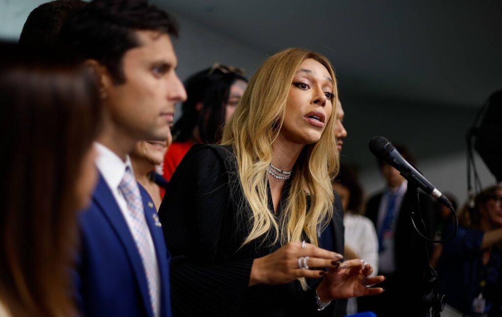 **O que significa ser mulher e como a misoginia é abordada na política brasileira?** A questão do que significa ser **mulher** e como a **misoginia** é tratada na política brasileira tornou-se um tema central em uma intensa **guerra cultural**. Segundo uma publicação da Folha, essa disputa foi intensificada pela indicação de Erika Hilton, uma deputada trans, para a presidência da Comissão de Defesa dos Direitos da Mulher da Câmara. Além disso, a aprovação de um projeto de lei no Senado que criminaliza a misoginia também contribuiu para o acirramento do debate. **Por que a indicação de Erika Hilton gerou controvérsia?** A nomeação de Erika Hilton gerou controvérsia porque trouxe à tona a discussão sobre o que é ser mulher. De acordo com a publicação, a esquerda defende uma visão baseada nas teorias de gênero, que propõem o conceito de "mulheridades", abrangendo mulheres cis, trans e pessoas não binárias. Essa perspectiva legitima a presença de Erika Hilton na comissão, pois não há restrições legais que a impeçam de ocupar o cargo. No entanto, a direita argumenta que a definição de mulher deve ser baseada em critérios biológicos, o que gera um conflito de visões. **Como a sociedade brasileira reagiu a essa nomeação?** Uma pesquisa do Real Time Big Data revelou que 82% da população tomou conhecimento da nomeação de Erika Hilton, e 84% desse grupo discordam de sua condução ao posto. Isso sugere um consenso relativo na sociedade que transcende a polarização política. A publicação destaca que 61% dos entrevistados concordam com as declarações do apresentador Ratinho, que questionou a identidade de gênero de Erika Hilton. **Qual é o impacto do projeto de lei que criminaliza a misoginia?** O projeto de lei 896/23, aprovado pelo Senado, visa criminalizar a misoginia. No entanto, a proposta enfrenta críticas, principalmente por não definir claramente o conceito de "mulher", o que poderia permitir que pessoas trans também reivindiquem a proteção legal. Além disso, há preocupações de que o escopo das condutas criminalizadas seja muito amplo, ameaçando a liberdade de expressão. **Por que a esquerda enfrenta dificuldades nesse debate?** A publicação aponta que a esquerda enfrenta dificuldades nesse debate porque sua postura rígida em relação ao tema contrasta com opiniões mais consensuais em outros assuntos identitários. A falta de diálogo e a dificuldade em convencer a população são vistas como problemáticas, especialmente em um ano eleitoral. A esquerda é criticada por não conseguir conquistar a confiança da maioria, o que pode resultar em prejuízos eleitorais. **Quais são as implicações políticas dessa guerra cultural?** A radicalização da guerra cultural pode beneficiar partidos de direita e alguns parlamentares da esquerda identitária, que dependem do eleitorado de nicho para renovar seus mandatos. A publicação sugere que a esquerda, comprometida com o enfrentamento das estruturas capitalistas, está acumulando desconfiança da população devido a essa situação. Em resumo, o debate sobre o que significa ser mulher e a criminalização da misoginia no Brasil reflete uma complexa guerra cultural que envolve questões de identidade, representatividade e liberdade de expressão. A esquerda enfrenta desafios significativos para navegar nesse cenário, especialmente em um contexto político polarizado.